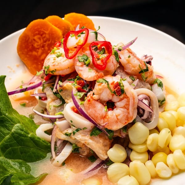 Peruvian ceviche with shrimp, squid, red onion, corn, sweet potato, and cilantro.