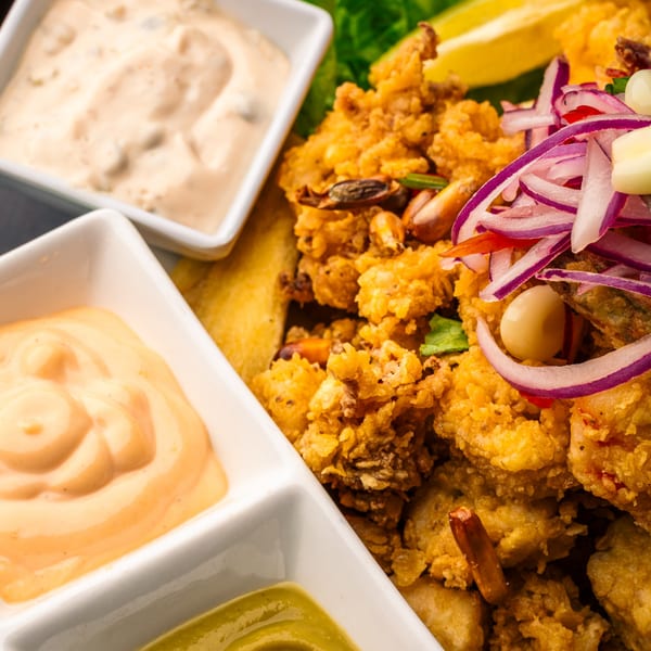 Peruvian fried seafood with red onion, corn, plantains, and three dipping sauces.